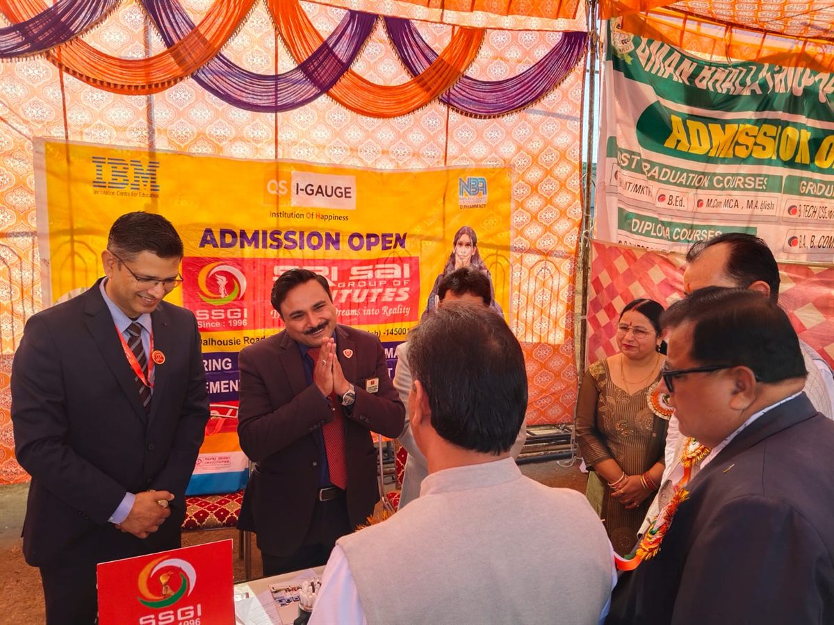 Admission fair representatives interacting with visitors at a booth