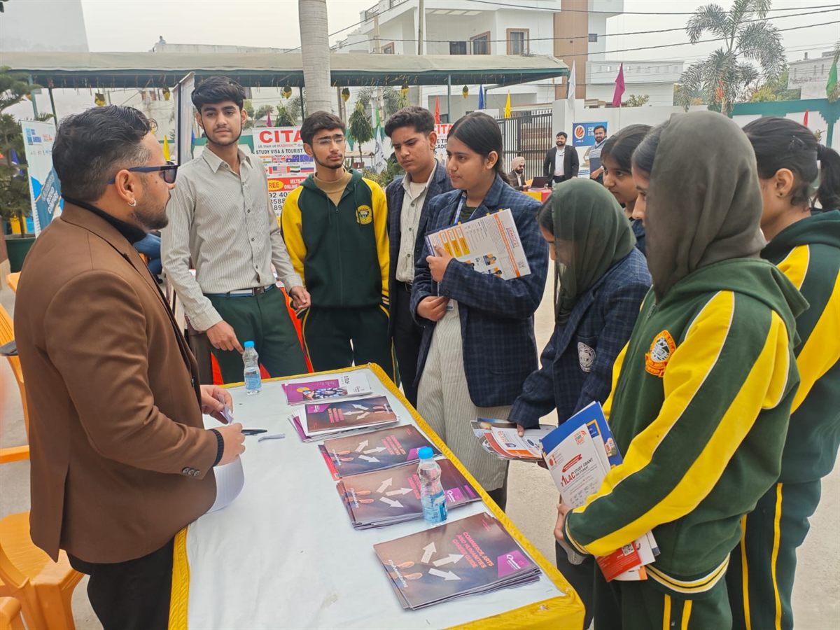 Students receiving admission guidance at an outdoor counselling desk