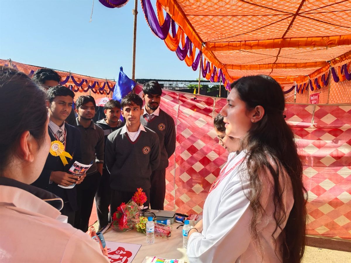 Students interacting with counsellors at an outdoor outreach stall