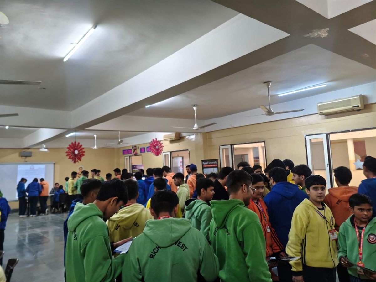 Students moving through a school event hall during admission outreach